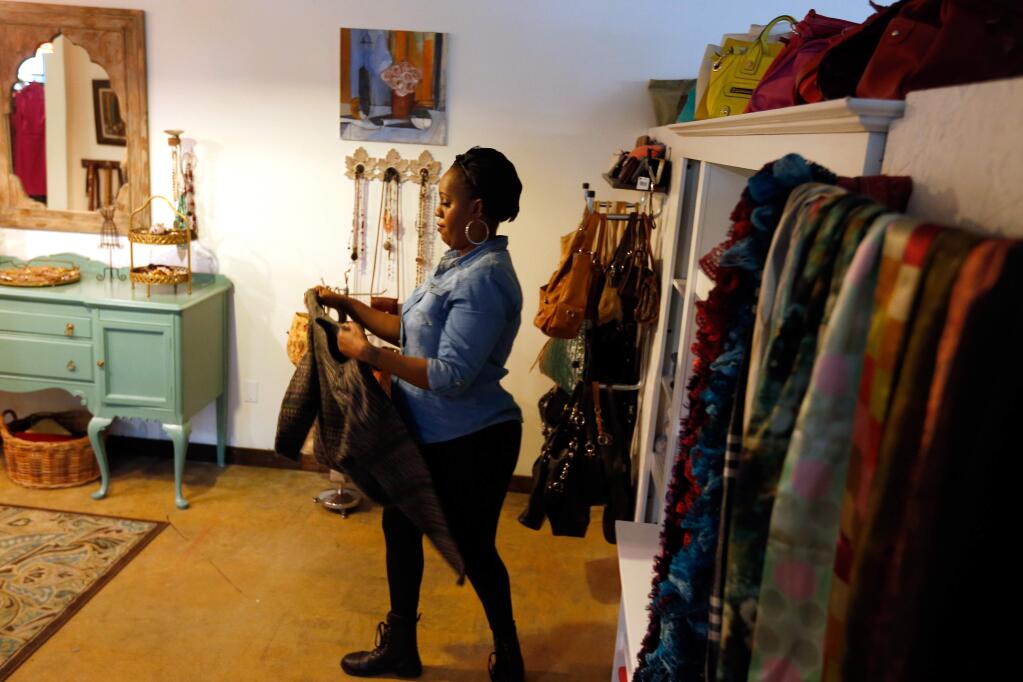 Jamekia Jackson picks out a sweater to try on at Work: Ready Apparel in Petaluma, California, on Wednesday, February 3, 2016. Work: Ready Apparel is a clothing boutique run by the Committee on the Shelterless (COTS) where its Work: Ready program clients can acquire suitable interview and work clothing for free. (Alvin Jornada / The Press Democrat)