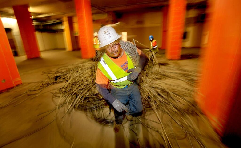 Miles of phone cable are pulled from Santa Rosa's four story AT&T building, Tuesday March 25, 2014, as work begins on the remodeling and overhaul of the entire building which will house, among other things, a wine museum. (Kent Porter / Press Democrat) 2014