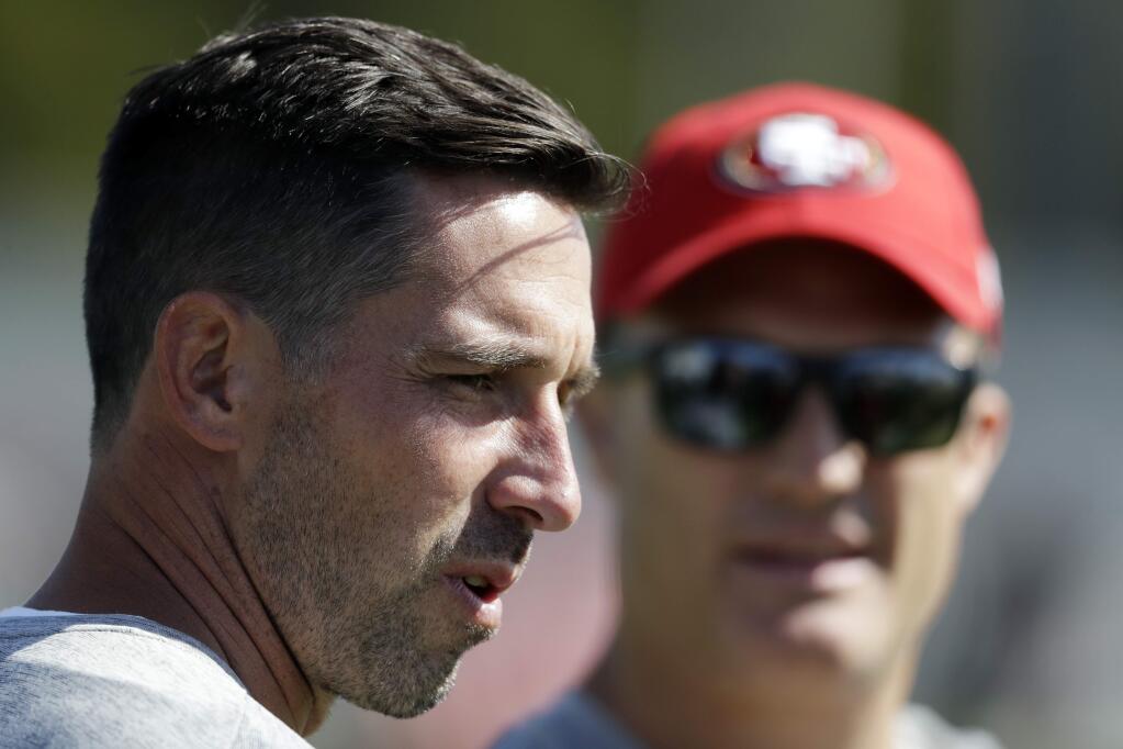 San Francisco 49ers head coach Kyle Shanahan, left, watches practice with general manager John Lynch during training camp Friday, July 28, 2017, in Santa Clara. (AP Photo/Marcio Jose Sanchez)