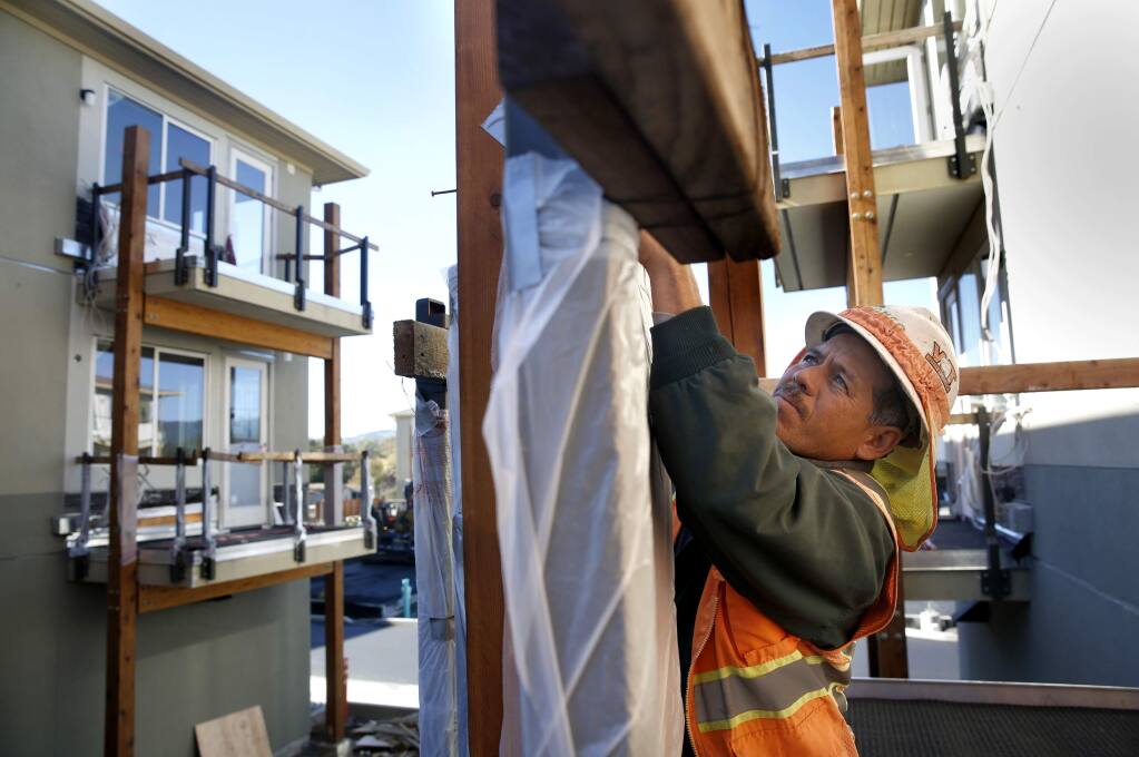 Javier Rodriguez of R.E. Maher Inc. prepares a balcony for concrete to be poured as work is ongoing at the new Fetters Apartment complex, part of the Sonoma Springs Hub,in Sonoma, on Wednesday, November 16, 2016. (BETH SCHLANKER/ The Press Democrat)
