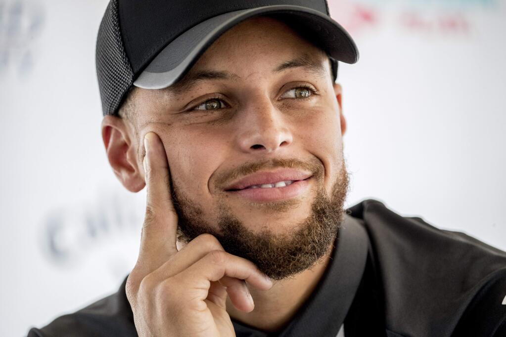 Golden State Warriors guard Stephen Curry attends a news conference at Langston Golf Course in Washington, Monday, Aug. 19, 2019, where he announced that he would be sponsoring men's and women's golf teams at Howard University. (AP Photo/Andrew Harnik)