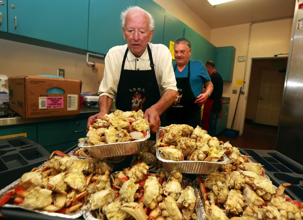 Ray Lazzini, left, and Randy Apel handled the kitchen duty at the North Bay Italian Cultural Foundation Crab Feed in Santa Rosa on Saturday night. (John Burgess/The Press Democrat)