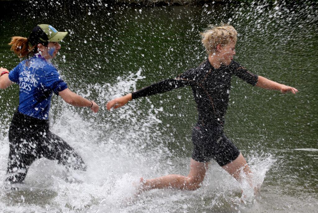 Contestants Dylan Anacleto-Black, 14, of Cotati, chases Jasper Caddell, 15, of Petaluma, both of 'River Town Racers,' in the water prior to the beginning of the 8 mile long course boat race at Steelhead Beach during the 7th Annual Great Russian River Race, in Forestville, Calif., on Saturday, June 3, 2017. (Photo by Darryl Bush / For The Press Democrat)