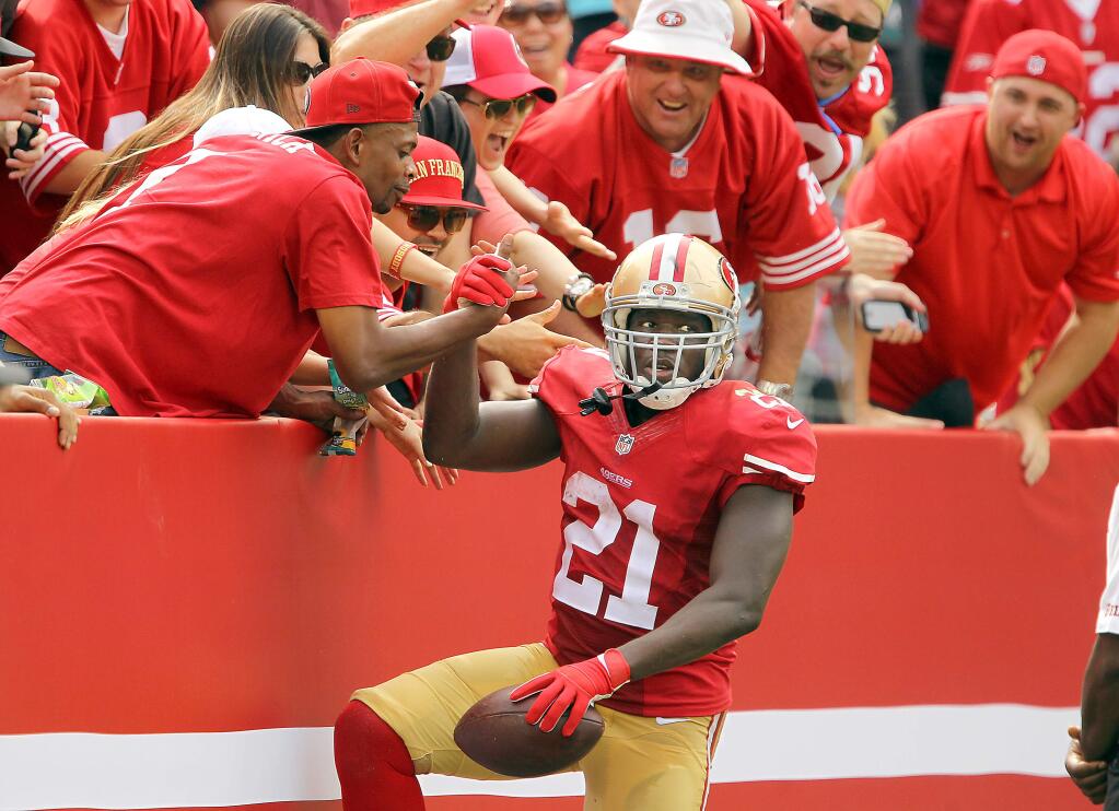 Frank Gore celebrates with fans after his 55-yard 2nd quarter touchdown reception. The 49ers beat the Eagles, 26-21, at Levi Stadium on Sunday, September 28, 2014.