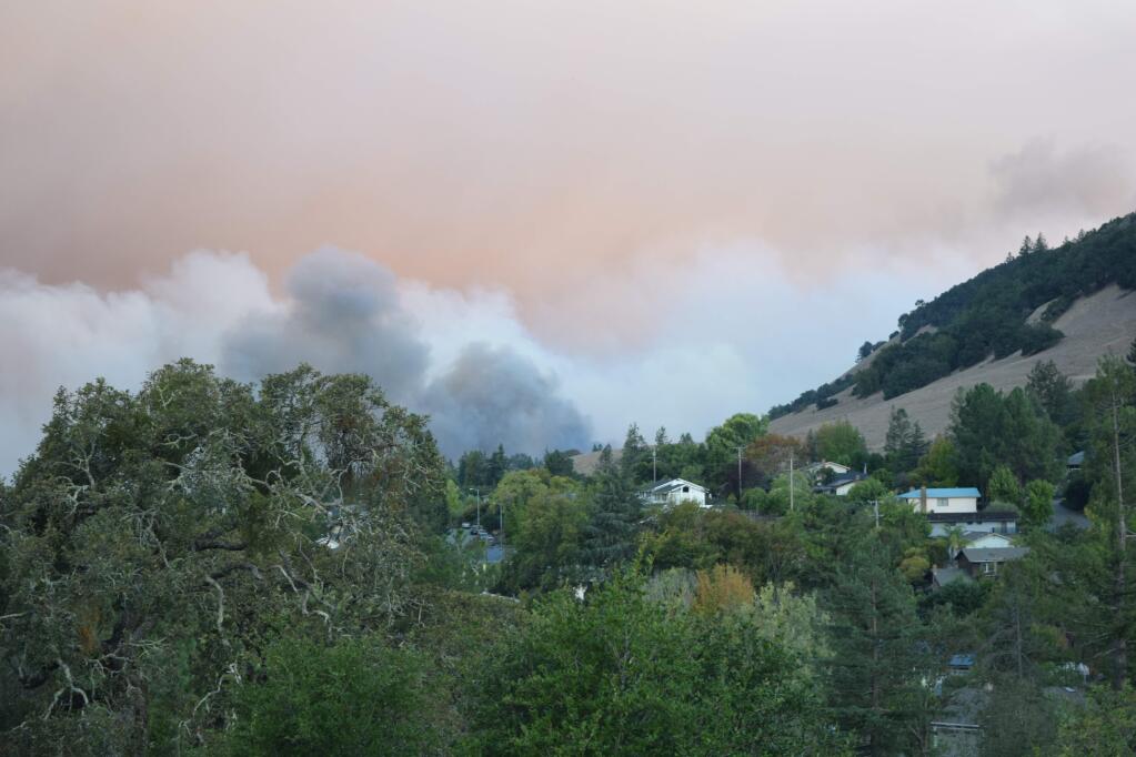 Smoke from the Tubbs fire billows over the hills in Rincon Valley. (PAUL GULLIXSON / The Press Democrat)