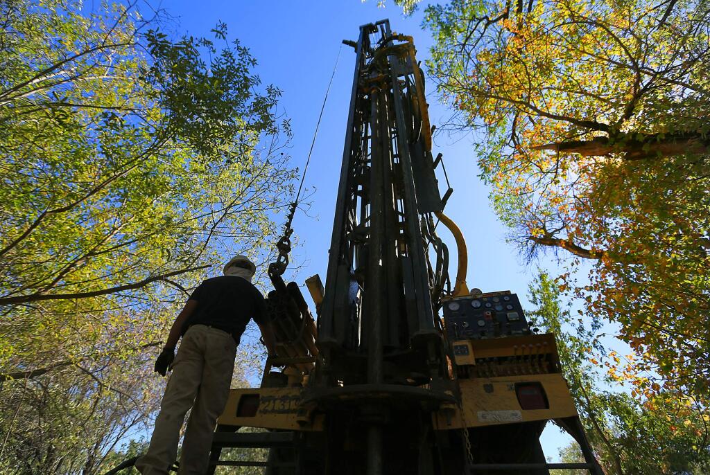 (FILE PHOTO) Well driller Tim Teller of Weeks Drilling monitors the boring of a test well Wednesday Sept. 4, 2013 in Cloverdale. (Kent Porter / Press Democrat)