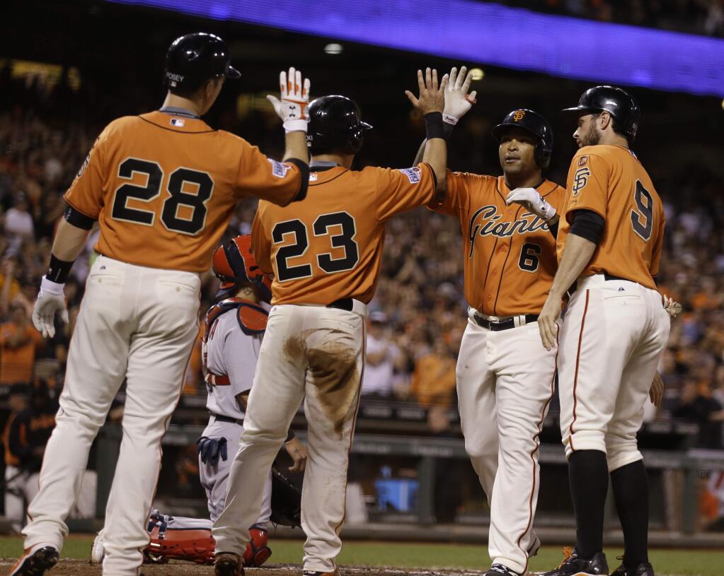 San Francisco Giants' Marlon Byrd, third from left, is congratulated by Buster Posey (28), Nori Aoki (23) and Brandon Belt, right, after hitting a grand slam off St. Louis Cardinals' Michael Wacha in the third inning of a game Friday, Aug. 28, 2015, in San Francisco. (AP Photo/Ben Margot)