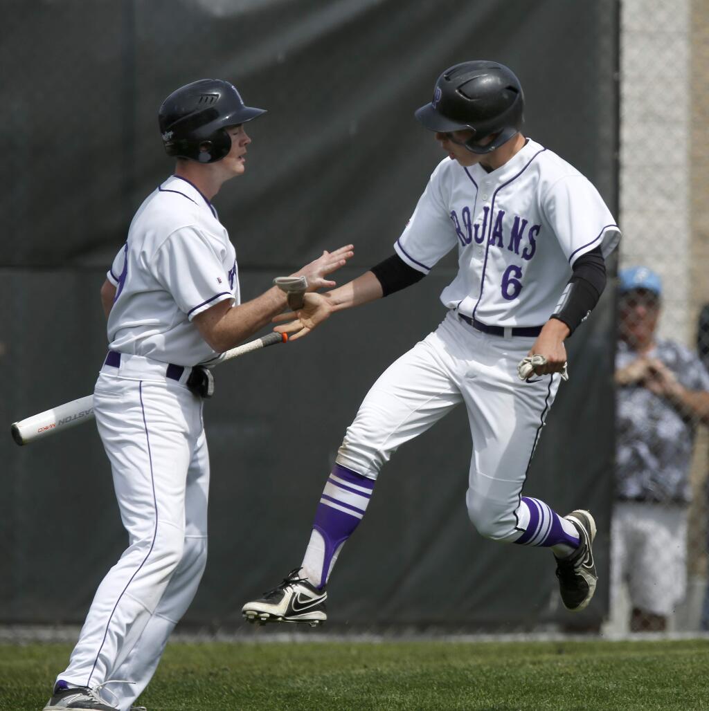 Petaluma runner Harrison Royall jumps up after scoring in the 4th inning during their game against Analy at Petaluma High School on Saturday, April 4, 2015 in Petaluma, California . (BETH SCHLANKER/ The Press Democrat)