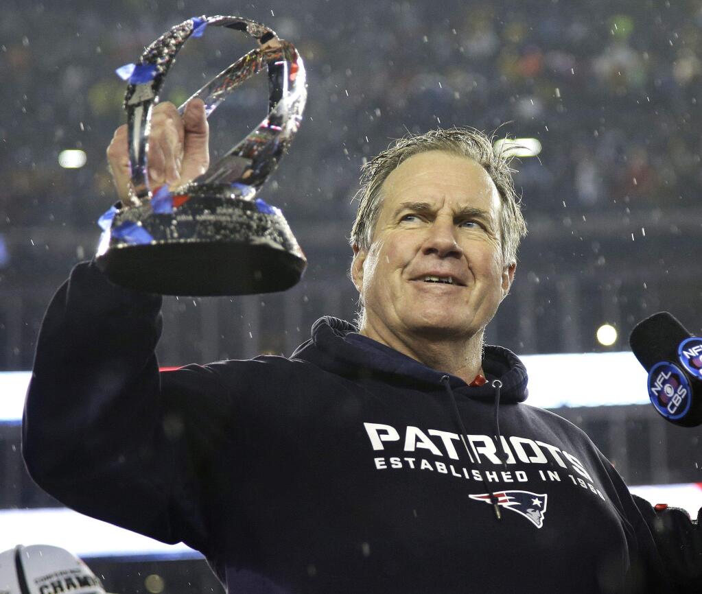 New England Patriots head coach Bill Belichick holds the championship trophy after the NFL football AFC Championship game Sunday. (Matt Slocum / Associated Press)