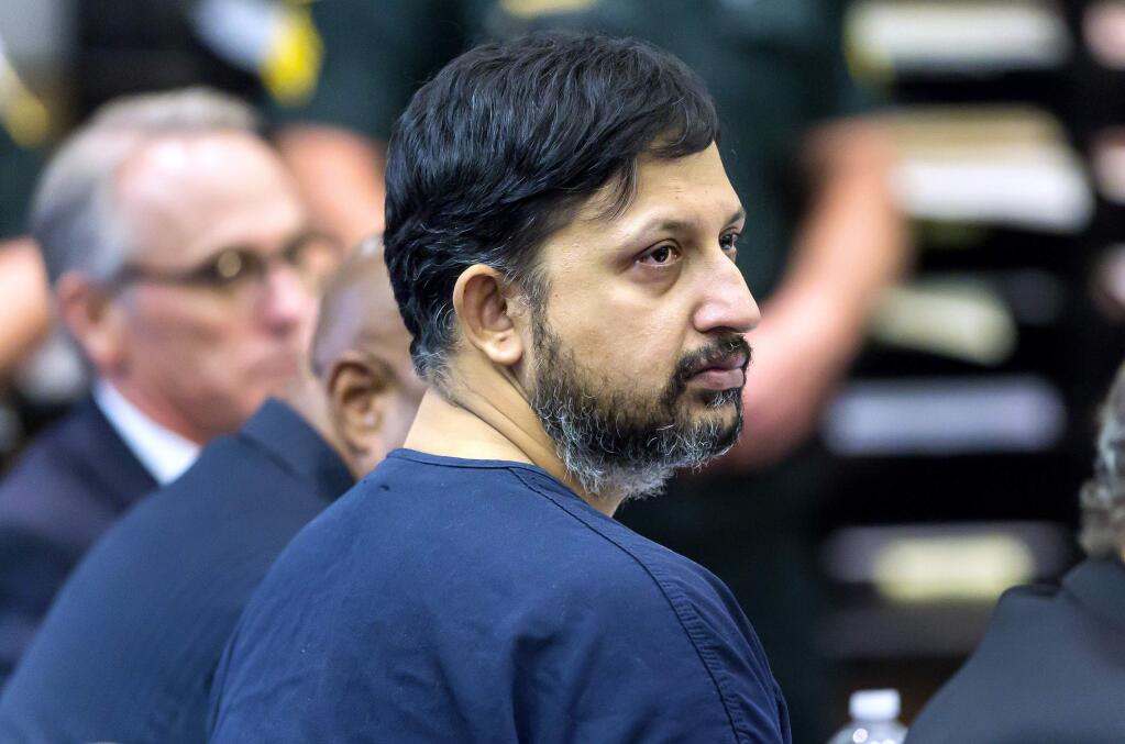 Nouman Raja listens to Chief Assistant State Attorney Adrienne Ellis during his sentencing hearing Thursday, April 25, 2019 in West Palm Beach, Fla. Raja, a former Palm Beach Gardens police officer, was convicted on one count each of manslaughter by culpable negligence and first-degree attempted murder. in the killing of stranded motorist Corey Jones Oct. 18, 2015. (Lannis Waters/Palm Beach Post via AP, Pool)