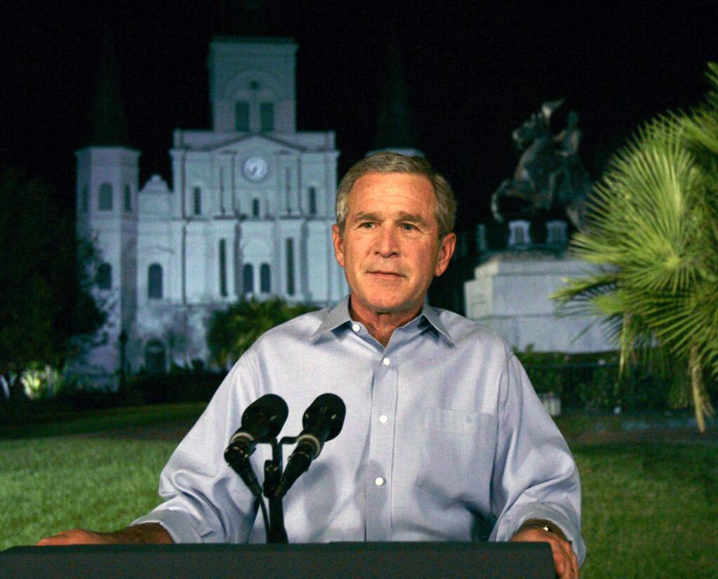 President George W. Bush speaks from Jackson Square in New Orleans following Hurricane Katrina. Bush was criticized for his response to the disaster. (SUSAN WALSH / Associated Press, 2005)