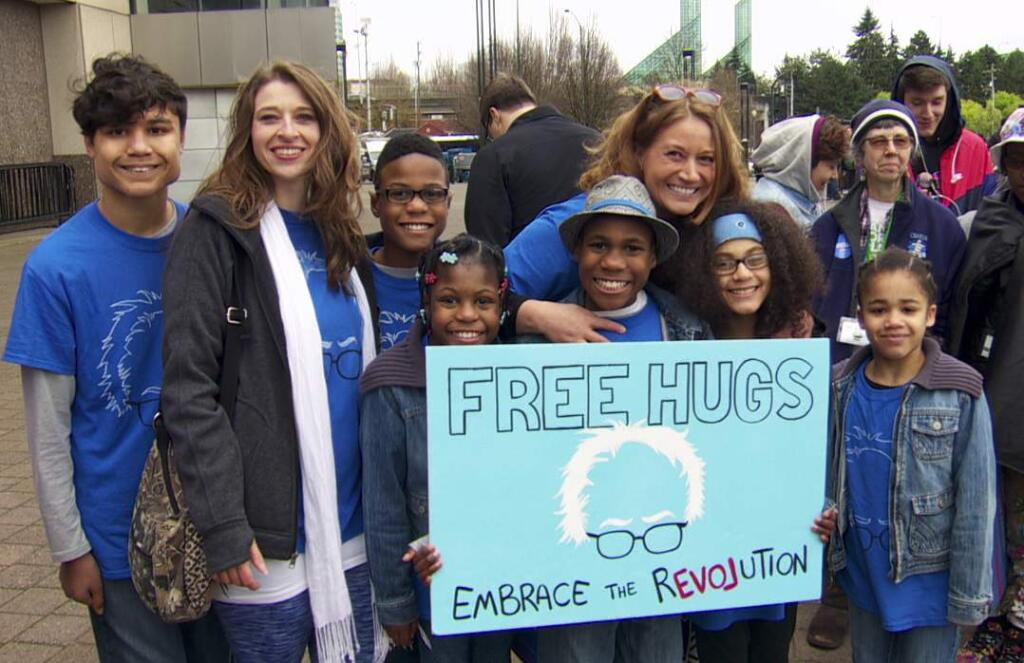 Sarah Margaret Hart (2nd from left), Jennifer Jean Hart (6th from left) and their six children at a Bernie Sanders rally in Portland, Oregon, Friday, March 25, 206. (Photo via KATU)