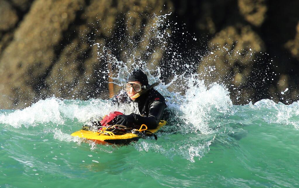 Patrick Reesink of Guerneville heads back in rough conditions with his limit of abalone at Ocean Cove on the last day of the season on Wednesday, November 30, 2016. (John Burgess/The Press Democrat)