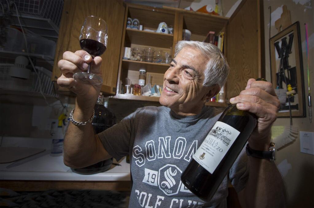 John Randazzo, in his garage 'lab', is involved in every aspect of home winemaking. He grows, crushes and bottles his own cabernet grapes. (Photo by Robbi Pengelly/Index-Tribune)