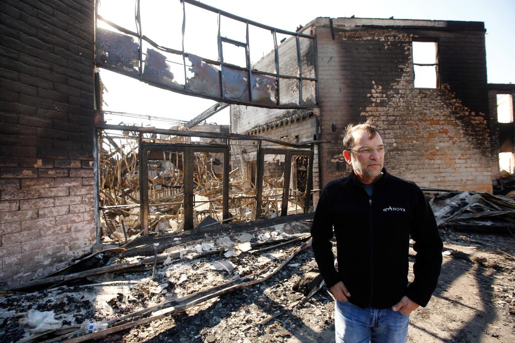 Anova Center for Education founder and CEO Andrew Bailey stands beside the northeast wing of the Luther Burbank Center for the Arts that was home to Anova's ACE Sonoma Campus, which was destroyed by the Tubbs fire, in Santa Rosa, California on Wednesday, October 18, 2017. (Alvin Jornada / The Press Democrat)