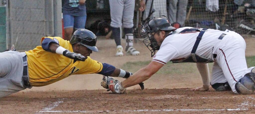 Bill Hoban/Index-TribuneSonoma Stomper catcher Daniel Comstock tags out a Vallejo baserunner in Saturday night's game. While the Stompers lost Saturday, they beat Vallejo 6-5 on Sunday to regain first place with nine games left on the schedule.