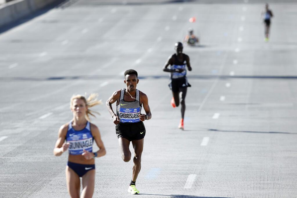 Ghirmay Ghebreslassie, of Eritrea, second left, pulls away from Kenya's Lucas Rotich, second right, and Lelisa Desisa, of Ethiopia, far right, during the New York City Marathon, Sunday, Nov. 6, 2016, in New York. (AP Photo/Jason DeCrow)