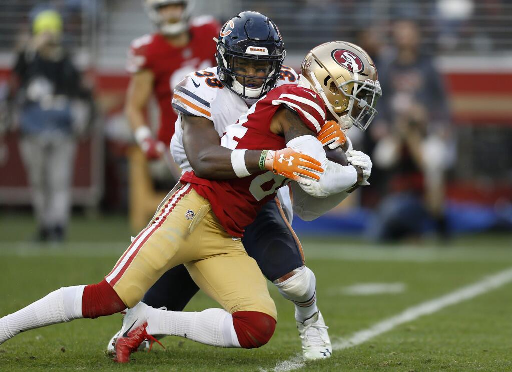 Chicago Bears cornerback Kyle Fuller (23) tackles San Francisco 49ers wide receiver Kendrick Bourne (84) during the second half of an NFL football game in Santa Clara, Calif., Sunday, Dec. 23, 2018. (AP Photo/D. Ross Cameron)