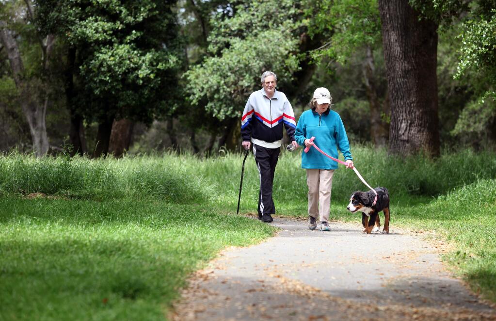 John, 70, and Patricia Hansen, 66, walk their dog, Sophie, around Ragle Ranch Park, in Sebastopol, on Wednesday, May 11, 2011.