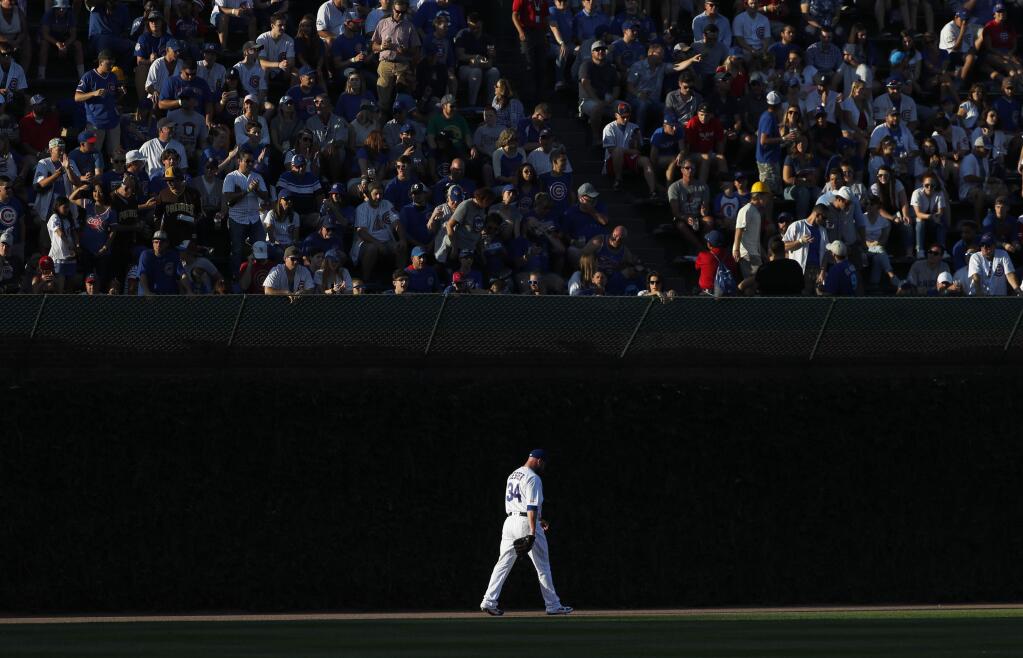 Chicago Cubs starting pitcher Jon Lester walks to the bullpen in left field to warm up as the sun sets before a baseball game between the Cubs and the Oakland Athletics Tuesday, Aug. 6, 2019, in Chicago. (AP Photo/Charles Rex Arbogast)