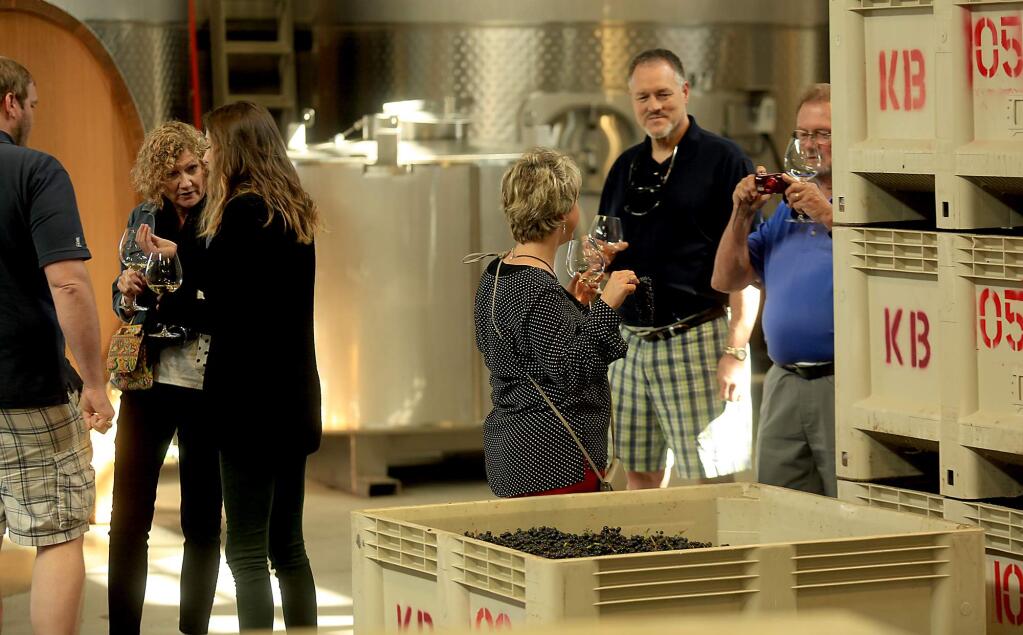 A wine tasting tour gets a peek at the crush pad at Kosta Browne Winery in The Barlow center in Sebastopol, Monday August 22, 2016. (Kent Porter / The Press Democrat) 2016