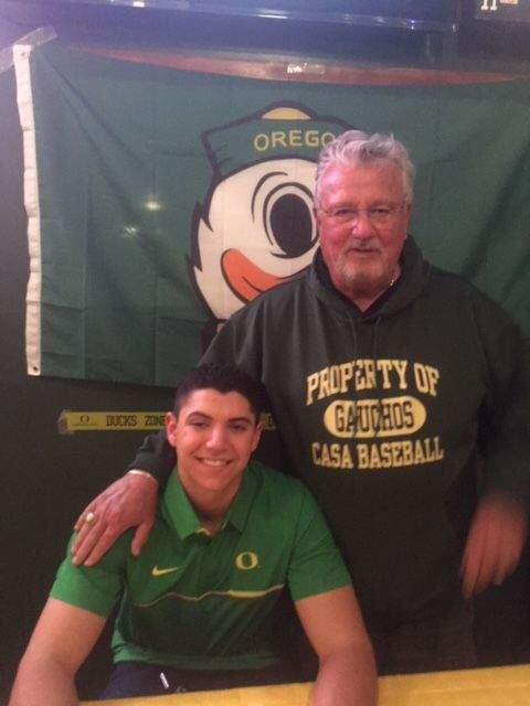 SUBMITTED PHOTOCasa Grande High School's A.J. Miller, with assistant coach Dominic Wirtz, signs a Letter of Intent to play baseball for the University of Oregon.