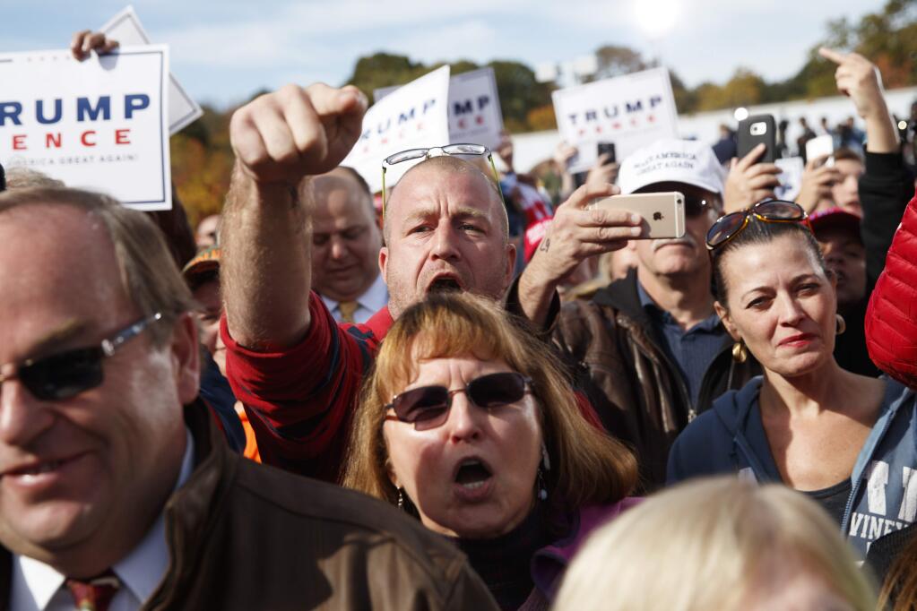 Fred Bracken of Buffalo, N.Y., yells at reporters as he arrives for a campaign rally with Republican presidential candidate Donald Trump, Saturday, Oct. 15, 2016, in Portsmouth, N.H. (AP Photo/ Evan Vucci)