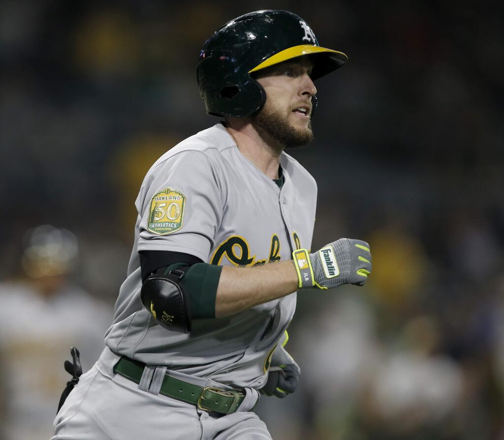 The Oakland Athletics' Jed Lowrie watches his two-run home run during the 10th inning against the San Diego Padres in San Diego, Tuesday, June 19, 2018. The Athletics won 4-2 in 10 innings. (AP Photo/Alex Gallardo)
