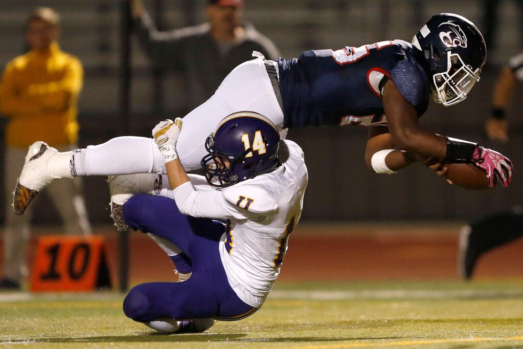 Rancho Cotate's Rasheed Rankin, right, leaps over Ukiah's Joseph Goodwin to get within one yard of the end zone during the first half between Ukiah and Rancho Cotate high schools on Friday, Oct. 26, 2018. (Alvin Jornada / The Press Democrat)