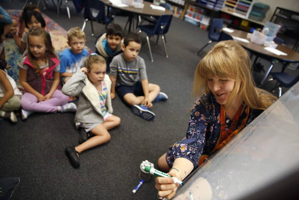 Teacher Meta George writes down her students descriptions of first grade during class at Hidden Valley Elementary School in Santa Rosa on Wednesday, August 22, 2018. (Beth Schlanker/ The Press Democrat)