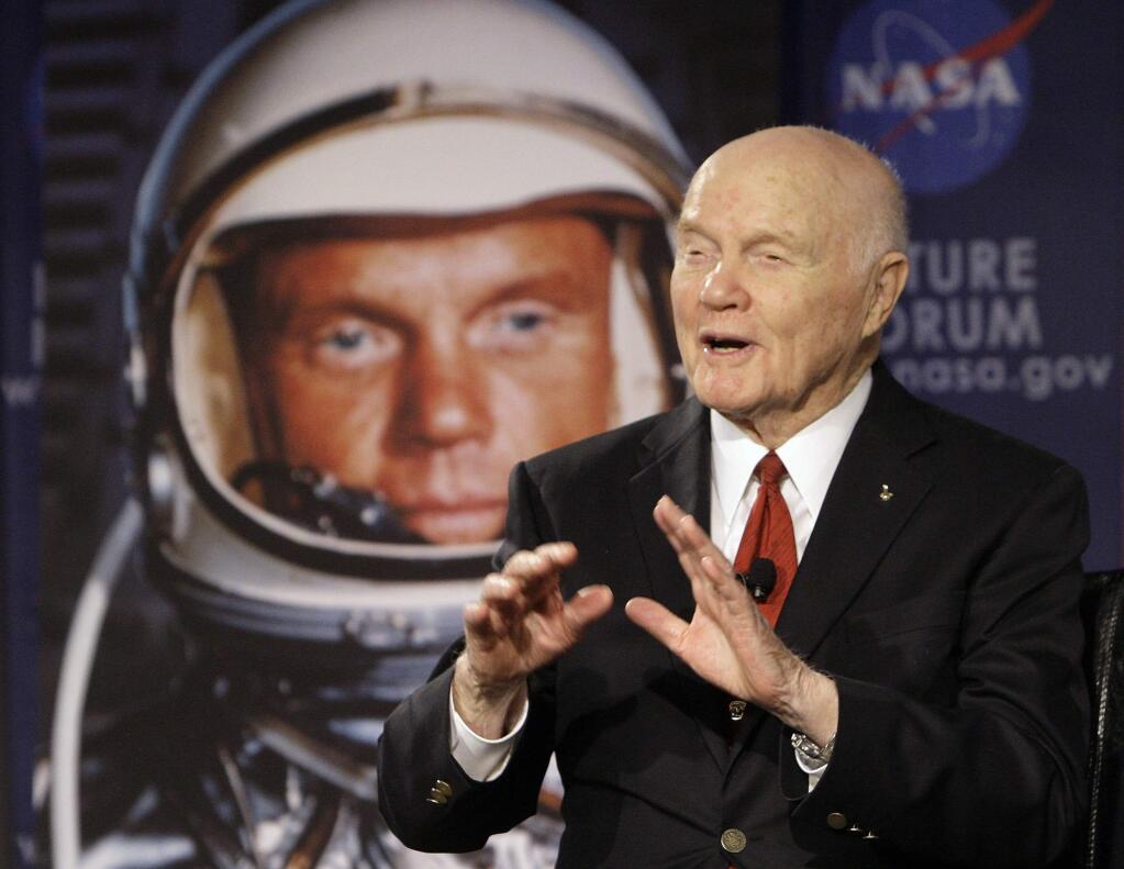 FILE - In this Feb. 20, 2012, file photo, U.S. Sen. John Glenn talks with astronauts on the International Space Station via satellite before a discussion titled 'Learning from the Past to Innovate for the Future' in Columbus, Ohio. Glenn, who was the first U.S. astronaut to orbit Earth and later spent 24 years representing Ohio in the Senate, has died at 95. (AP Photo/Jay LaPrete, File)