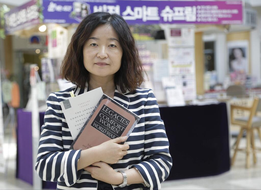 In this Tuesday, May 17, 2016 photo, Executive Director Korean American Forum of California, Phyllis Kim poses for a photo at the Galleria Market in Koreatown district of Los Angeles. Kim pushed for inclusion of Asian comfort women in the curriculum. How do you teach a history of the world in a state where nearly two-thirds of students are Latino or Asian, many from freshly immigrated families? That's the dilemma facing a California panel charged with establishing a history and social studies framework for the state's 6.2 million public school children. On Thursday, May 19, 2016, the Instructional Quality Commission is scheduled to vote to forward, or not, a new teaching framework to California's Board of Education. (AP Photo/Nick Ut)