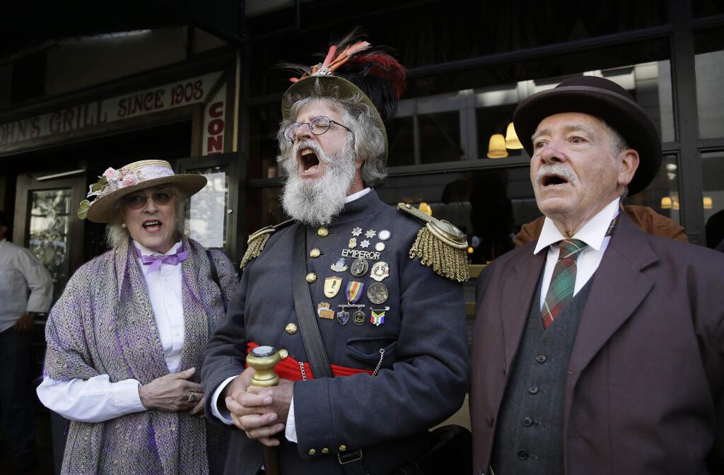 Joseph Amster, center, dressed as Emperor Norton, sings 'I Left My Heart in San Francisco,' outside John's Grill at the end of a parade to remember the great San Francisco 1906 earthquake and fire's 110th anniversary Friday, April 15, 2016, in San Francisco. The earthquake stuck on April 18, 1906. About 3,000 people died in the quake and 80% of the city was destroyed. At left is Kit Haskell and at right is Steve Johnson. (AP Photo/Eric Risberg)