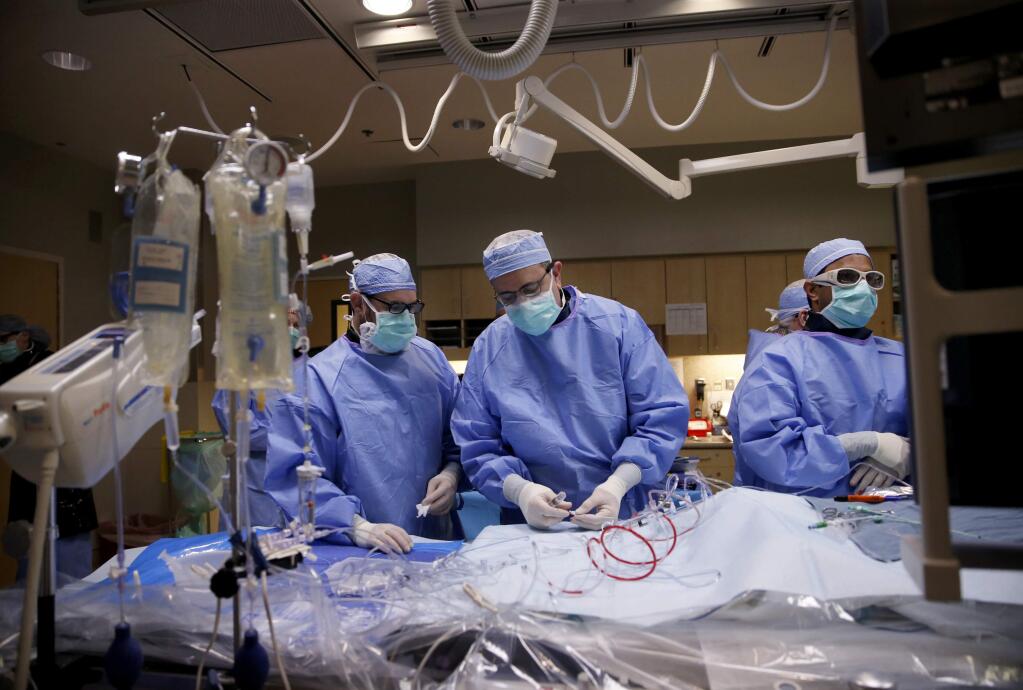 Cardiologist Dr. Patrick Coleman, center, performs a Transcatheter Aortic Valve Replacement procedure at Santa Rosa Memorial Hospital in Santa Rosa, on Wednesday, March 14, 2018. (BETH SCHLANKER/ The Press Democrat)