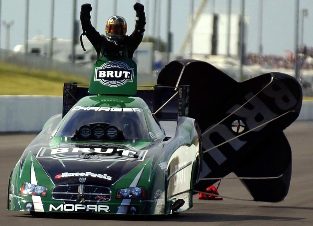 Ron Capps celebrates after defeating John Force in the funny car finals during the O'Reilly Summer Nationals race in Topeka, Kan., Sunday, May 28, 2006. (AP Photo/Topeka Capital-Journal, Mike Burley)
