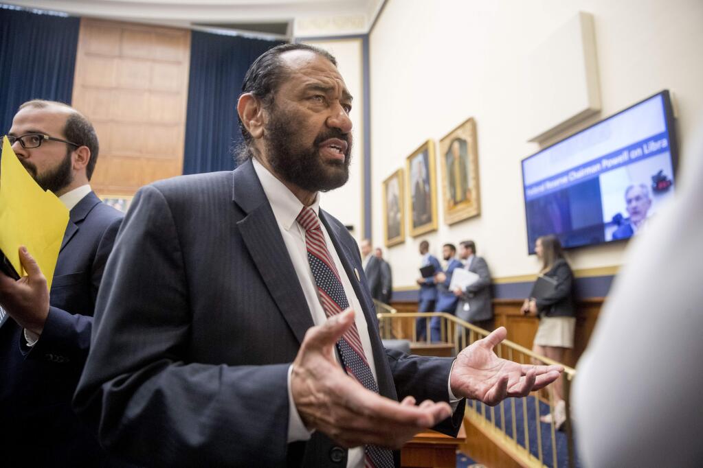 Rep. Al Green, D-Texas, right, speaks to visitors during a break from testimony from David Marcus, CEO of Facebook's Calibra digital wallet service, before a House Financial Services Committee hearing on Facebook's proposed cryptocurrency on Capitol Hill in Washington, Wednesday, July 17, 2019. Green has introduced a resolution in the House to impeach President Donald Trump. (AP Photo/Andrew Harnik)