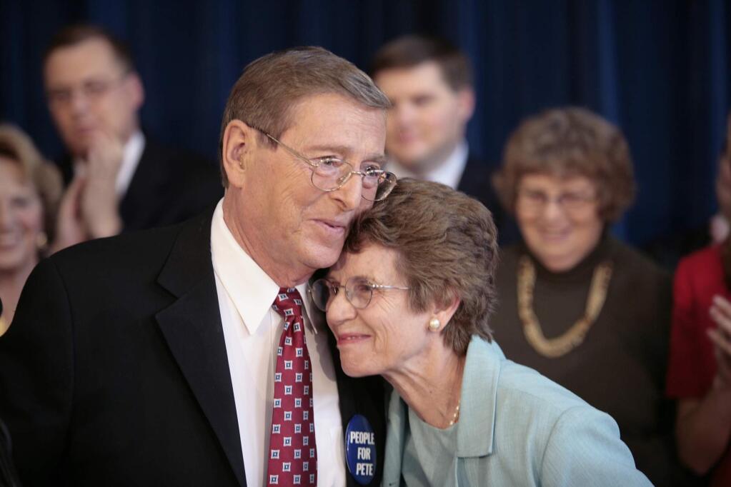 FILE - In this Thursday, Oct. 4, 2007, file photo, Sen. Pete Domenici, R-N.M., embraces his wife Nancy, right, as he finishes a news conference, in Albuquerque, N.M. Domenici, who became a power broker in the Senate for his work on the federal budget and energy policy, has died. Domenici was 85. The law firm of Pete Domenici Jr., the senator's son, confirms that the former lawmaker died Wednesday, Sept. 13, 2017, in Albuquerque but did not provide any details. (AP Photo/Toby Jorrin, File)