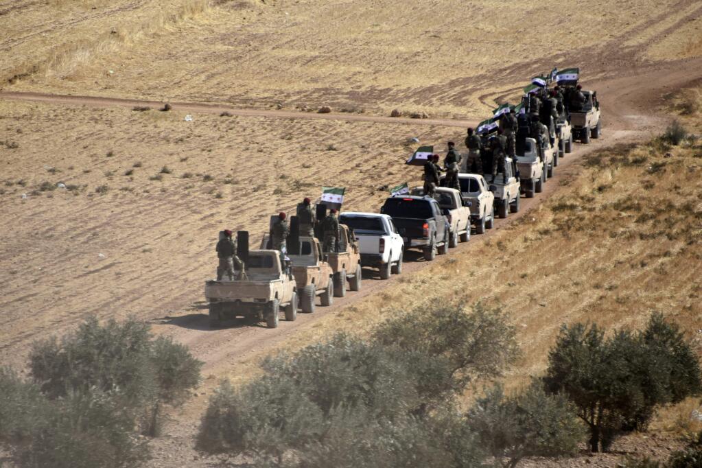 Turkey-backed FSA fighters are heading toward Syrian town of Tal Abyad from Turkish border town of Akcakale, Turkey, Thursday, Oct. 10, 2019. Turkish President Recep Tayyip Erdogan says that there have been 109 'terrorists killed' - a reference to Syrian Kurdish fighters - since Ankara launched an offensive into Syria the previous day. (DHA via AP)
