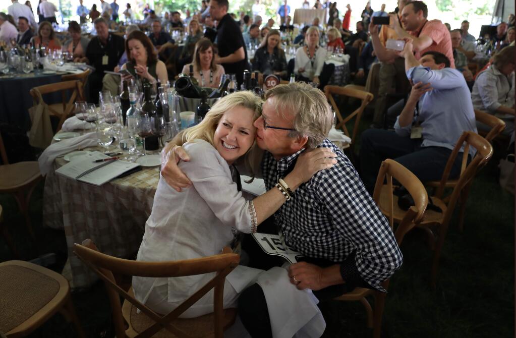 All smiles, Karen and Ted Davison of Florida celebrate a winning bid on a comination of wines from Brulian, Keller Estate, and Trombetta Family Wines, Friday, May 3, 2019 during the Sonoma County Barrel Auction in Forestville at MacMurray Ranch. (Kent Porter / Press Democrat) 2019