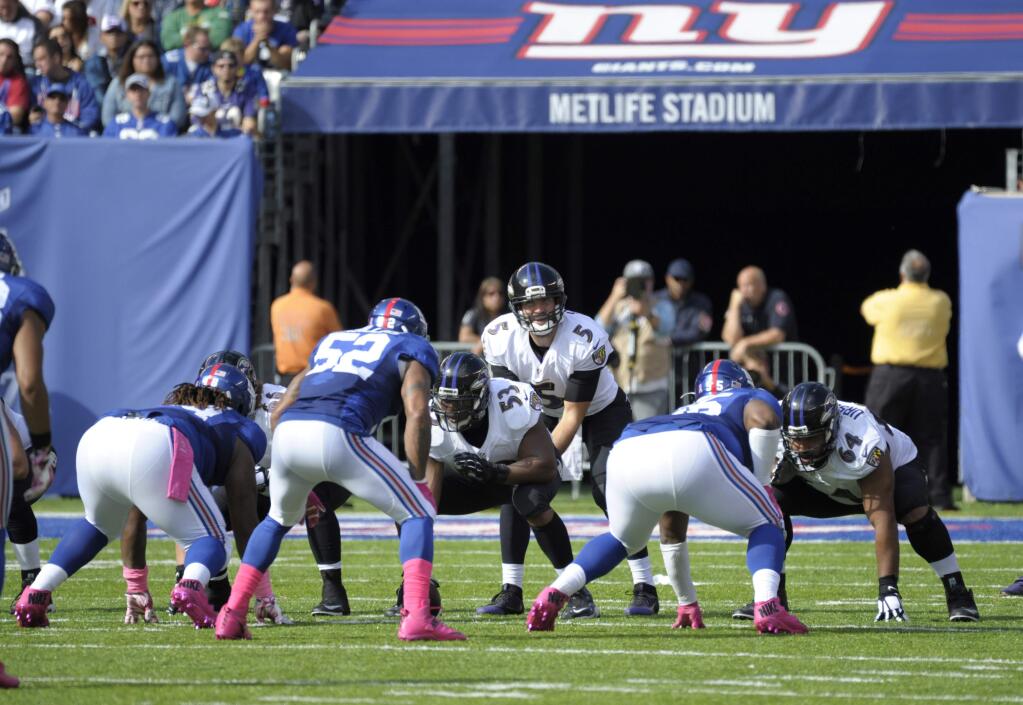 Baltimore Ravens quarterback Joe Flacco (5) prepares to take the snap from center Jeremy Zuttah (53) during the first half against the New York Giants Sunday, Oct. 16, 2016, in East Rutherford, N.J. (AP Photo/Bill Kostroun)