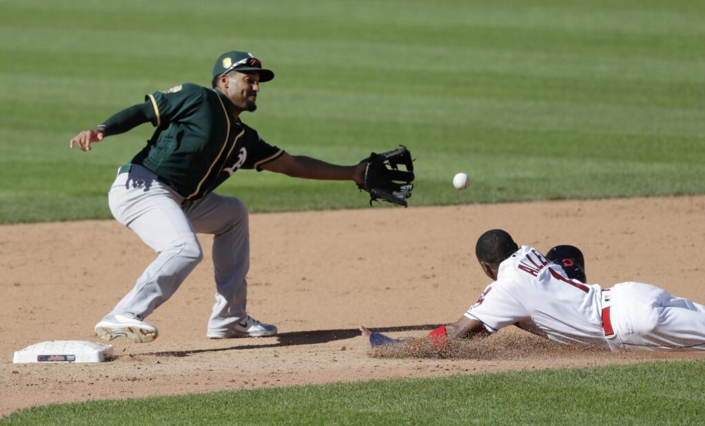 Cleveland Indians' Greg Allen slides safely into second base for a steal as Oakland Athletics' Marcus Semien waits for the ball in the fifth inning of a baseball game, Saturday, July 7, 2018, in Cleveland. (AP Photo/Tony Dejak)