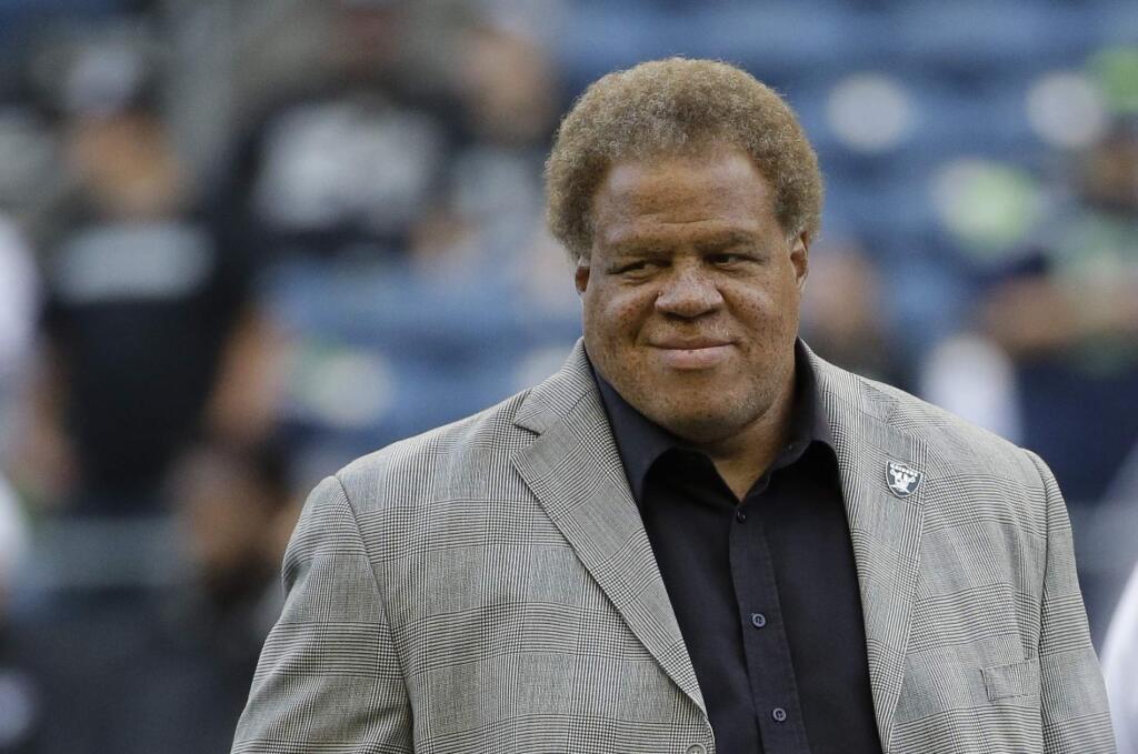 Raiders general manager Reggie McKenzie stands on the field before a preseason game against the Seahawks on Sept. 3, 2015. (Elaine Thompson / Associated Press)