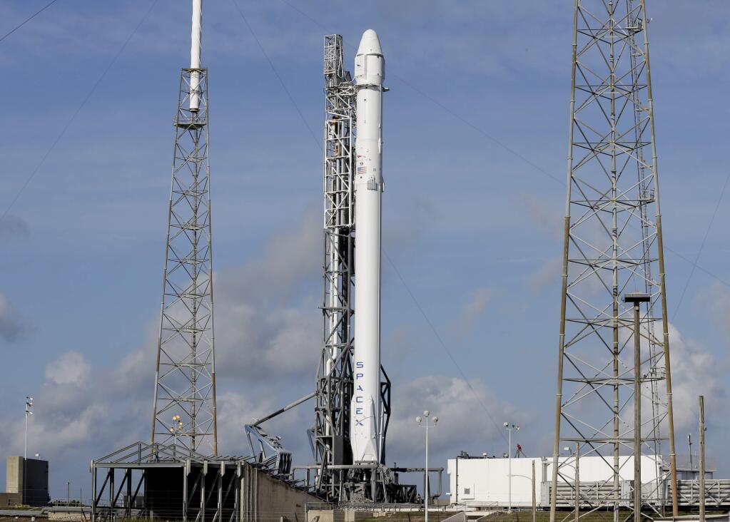 After a scrub on Monday, the Falcon 9 SpaceX rocket stands ready for another launch attempt at complex 40 at the Cape Canaveral Air Force Station in Cape Canaveral, Fla., Tuesday, April 14, 2015. This will be SpaceX's sixth commercial resupply services mission to the International Space Station. (AP Photo/John Raoux)