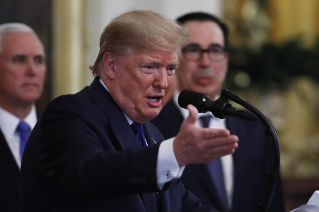 President Donald Trump, gestures as he and Chinese Vice Premier Liu He prepare to sign a U.S. China trade agreement, in the East Room of the White House, Wednesday, Jan. 15, 2020, in Washington. (AP Photo/Steve Helber)