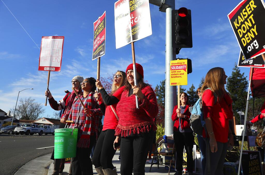 Mental health professionals Angela Sitka, left, Raman Goswami, Katrina Dill-Hendricks, and Liz Gachet, strike in front of the Kaiser Permanente Santa Rosa Medical Center campus, on the corner of Mendocino Avenue and Bicentennial Way, on Tuesday, December 11, 2018. (Christopher Chung/ The Press Democrat)
