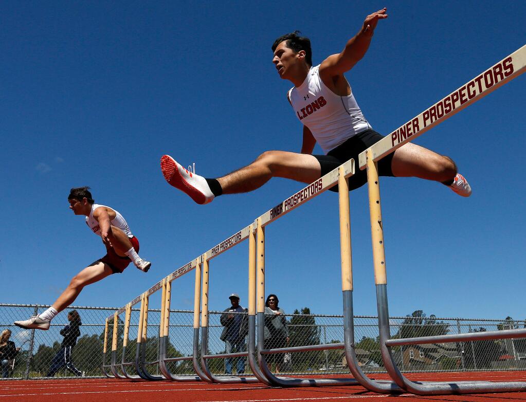 El Molino's Jack Fricker, left, and Clay Serrano race in the varsity boys 300-meter hurdles, winning first and second places, respectively, in the event, during the Sonoma County League track finals at Piner High School, in Santa Rosa, California on Saturday, May 13, 2017. (Alvin Jornada / The Press Democrat)