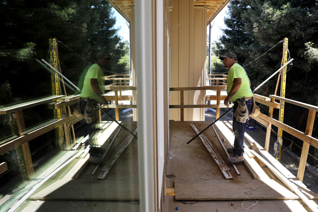 Tom Riggs of Riggs Drywall works on the interior of a unit at the Healdsburg Family Apartments under construction in Healdsburg on Tuesday, July 17, 2018. (Beth Schlanker/ The Press Democrat)