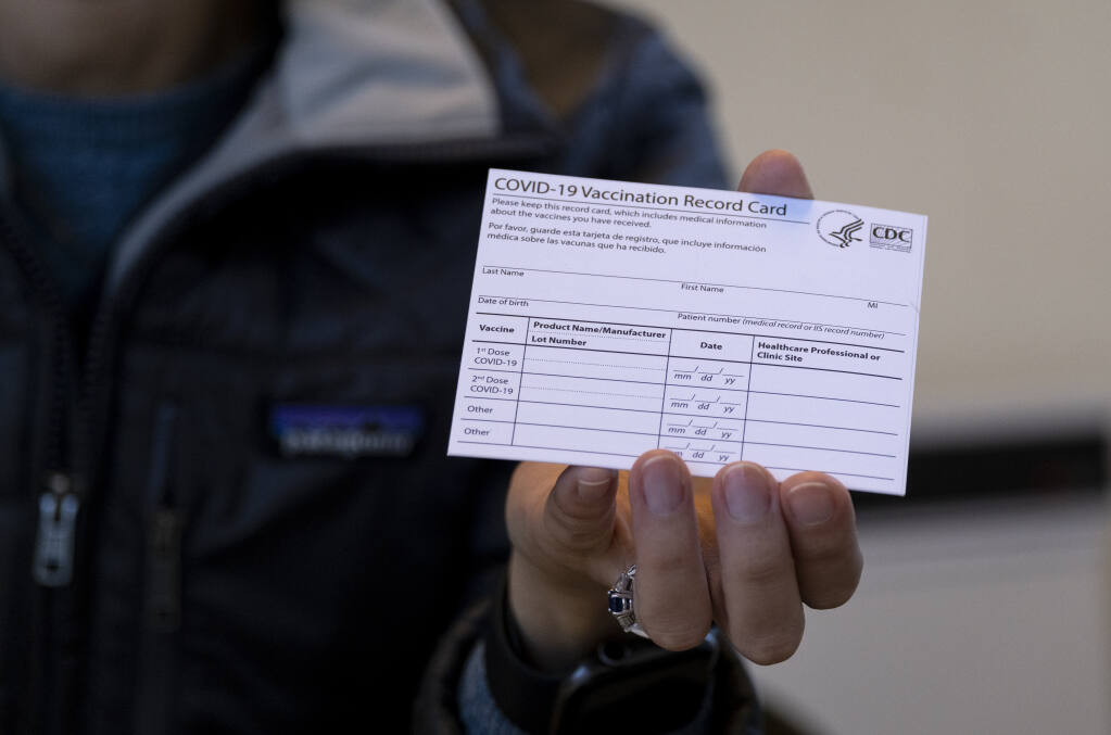 FILE - In this Jan. 10, 2021 file photo, Sarah Gonzalez of New York, a Nurse Practitioner, displays a COVID-19 vaccine card at a New York Health and Hospitals vaccine clinic in the Brooklyn borough of New York. (AP Photo/Craig Ruttle, File)