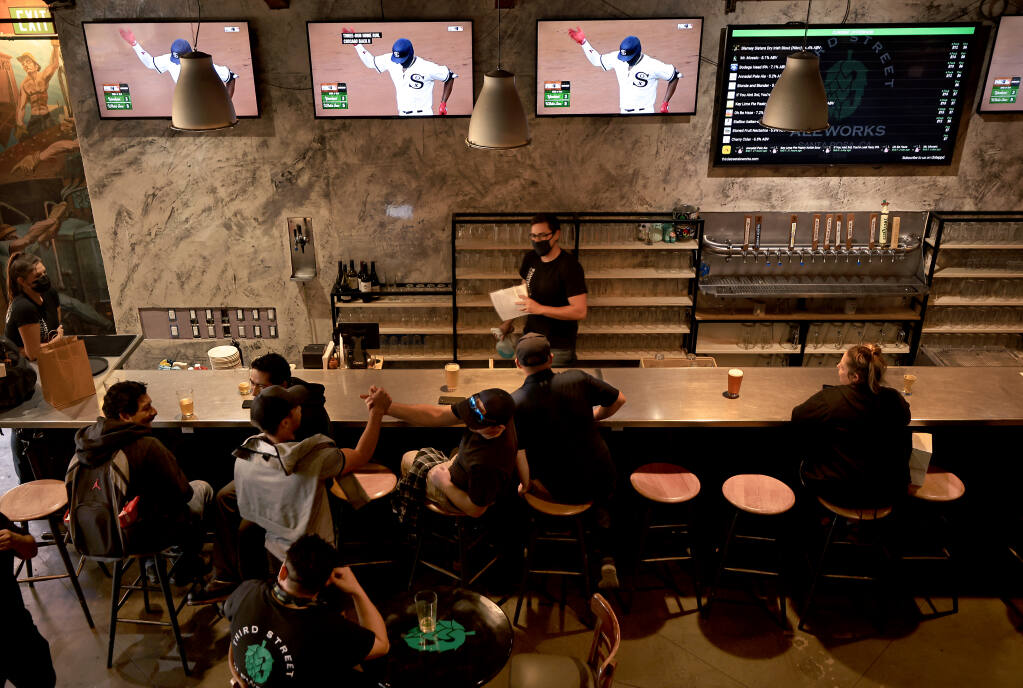 A Third Street Aleworks in Santa Rosa, a crowd begins to form for the evening dinner rush, Thursday, Aug. 12, 2021. (Kent Porter / The Press Democrat) 2021