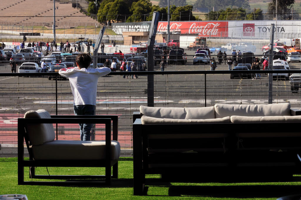 Rene Diaz, 10, of Santa Rosa, looks out at the Sonoma Drags and Drifts race event from the outdoor area of Turn 11, a new hospitality facility at Sonoma Raceway, Wednesday, May 17, 2023, in Sonoma. (Darryl Bush / For The Press Democrat)